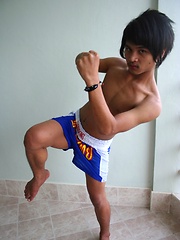 Cute gay Thai kickboxer posing and stripping