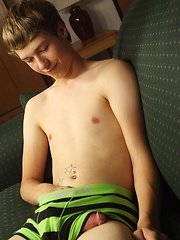 Smooth twink Levi Lee tugs on his hard cock.