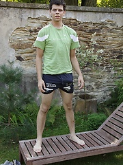 Peter Sweet in the backyard busting a nut on his stomach.